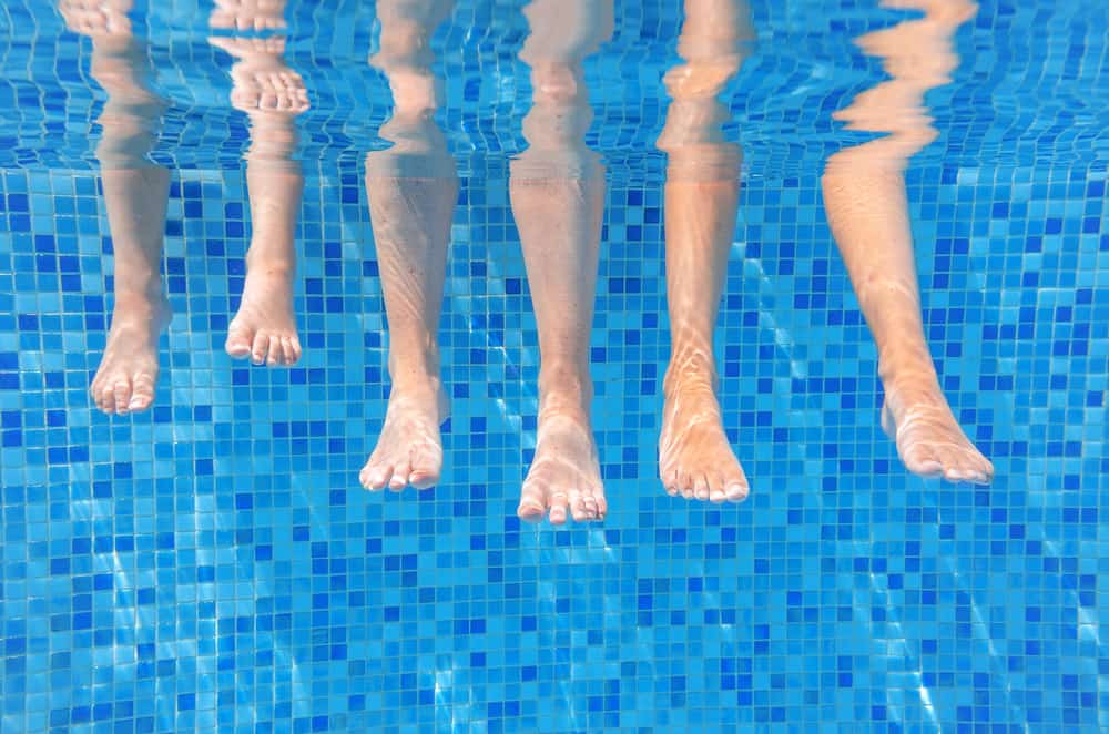 photo of feet in swimming pool